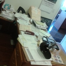 Disorganized desk with paper clutter