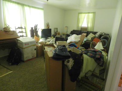 Disorganized living room with unpacked boxes