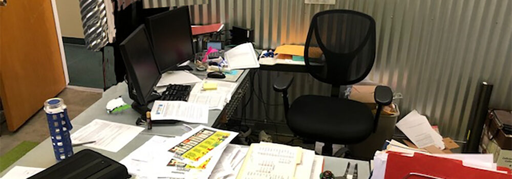 messy, cluttered professional desk