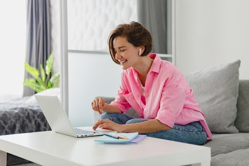 Woman working on computer with work life balance and happy